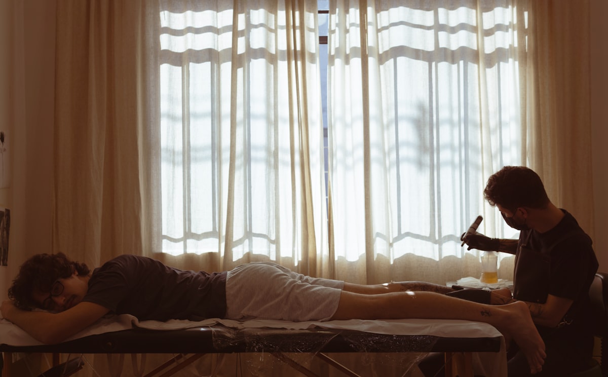 a man lying on a bed with a woman lying on the bed