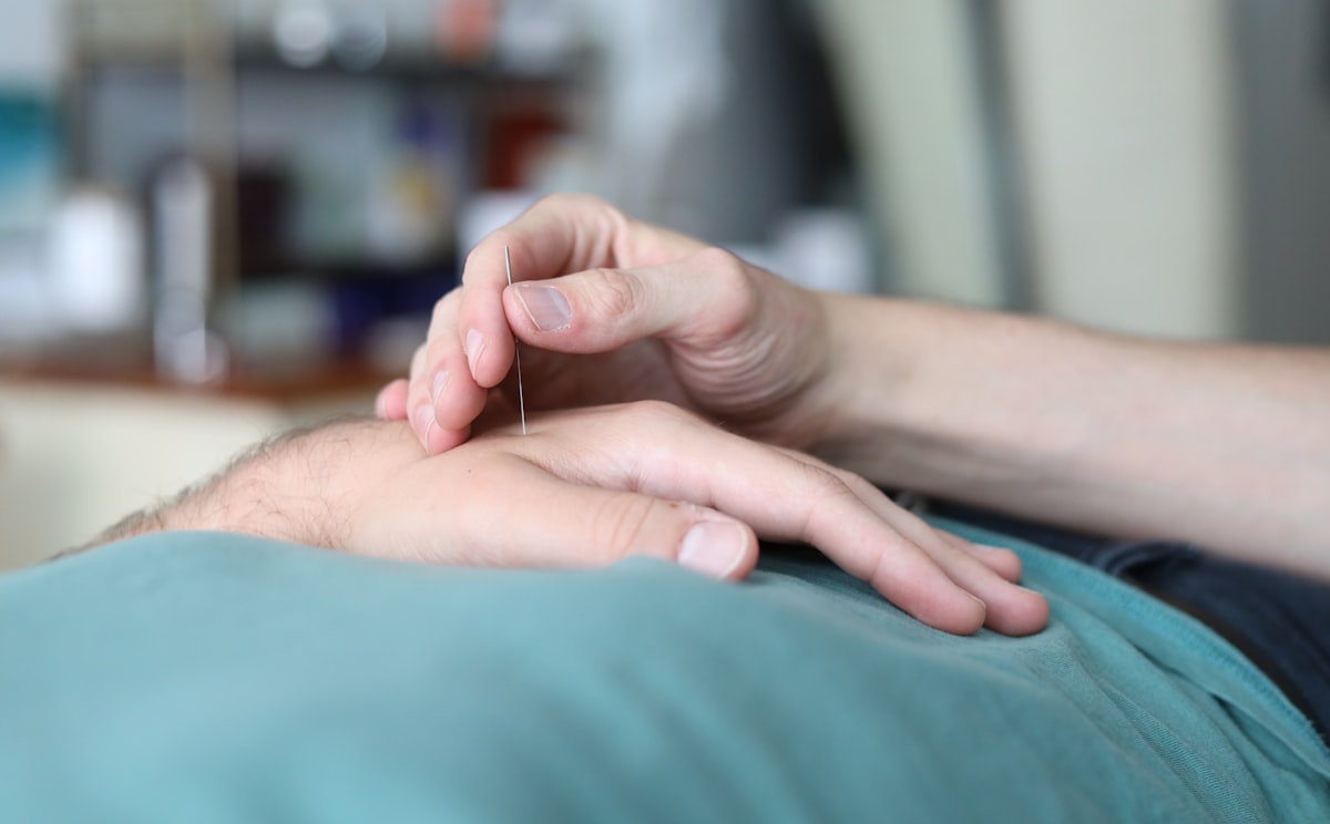 A person is holding the hand of another person